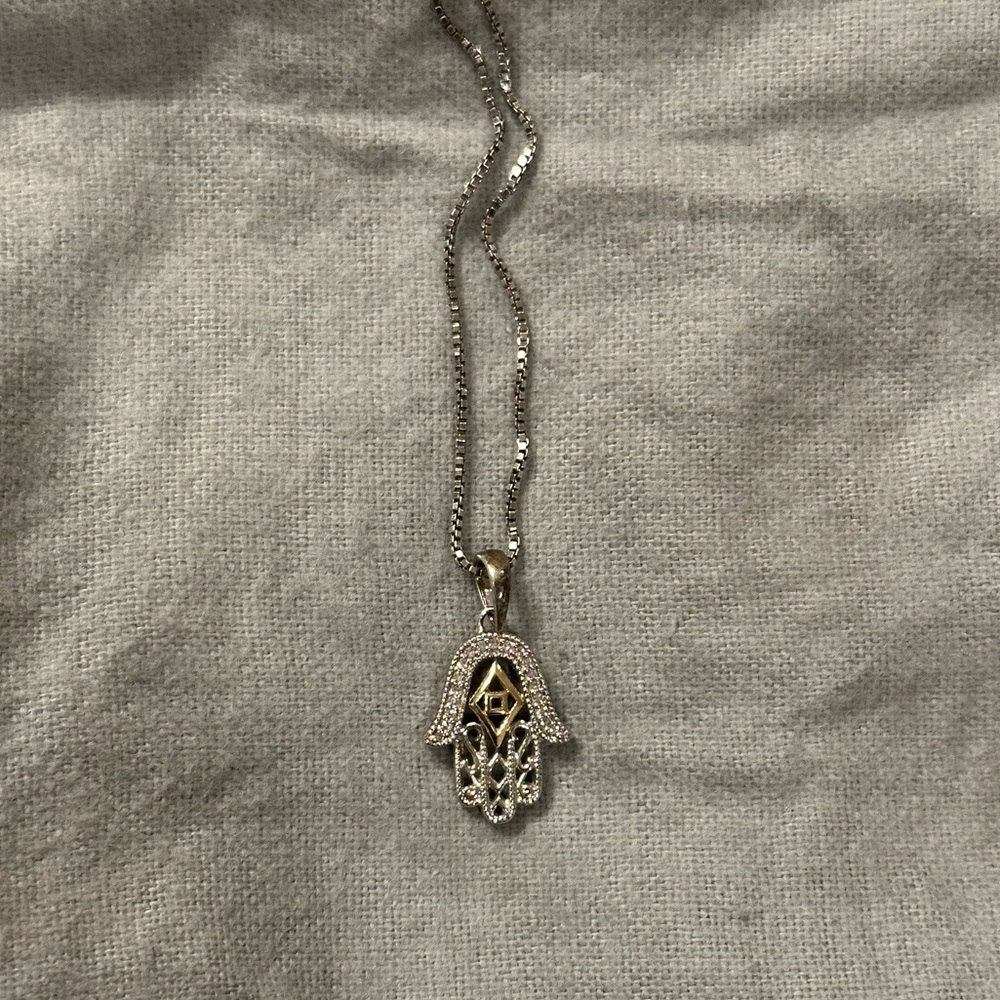 Sterling silver hamsa necklace on 18” chain.